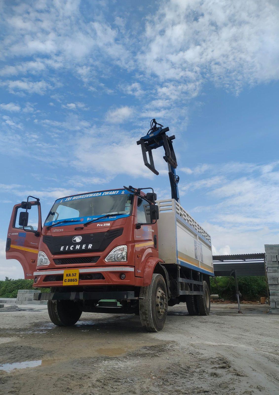 Brick grabber raised on a truck-mounted crane boom