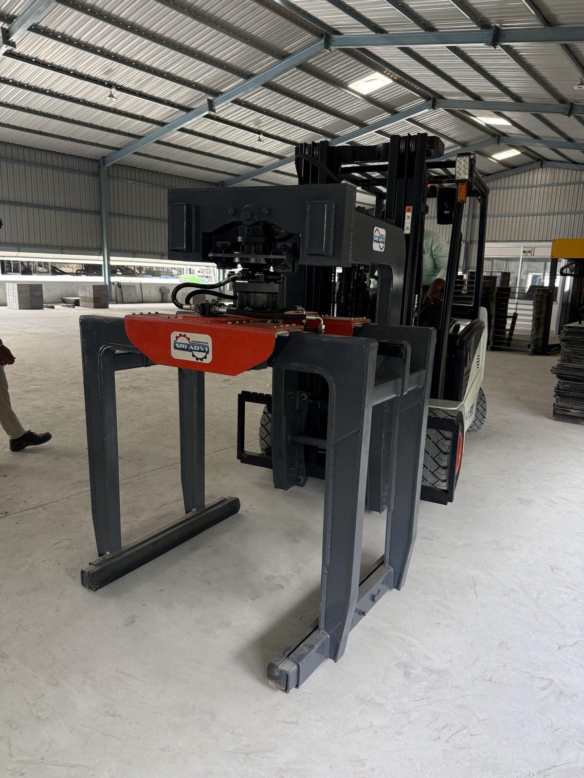 Forklift fitted with an SAE 02 brick grabber in the workshop